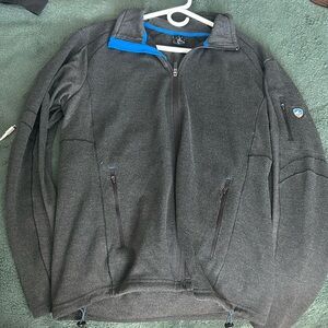 Dark grey Kühl jacket with blue trip